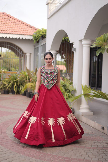 Red lehenga choli with multicolored patterned blouse and cream floral border detailing
