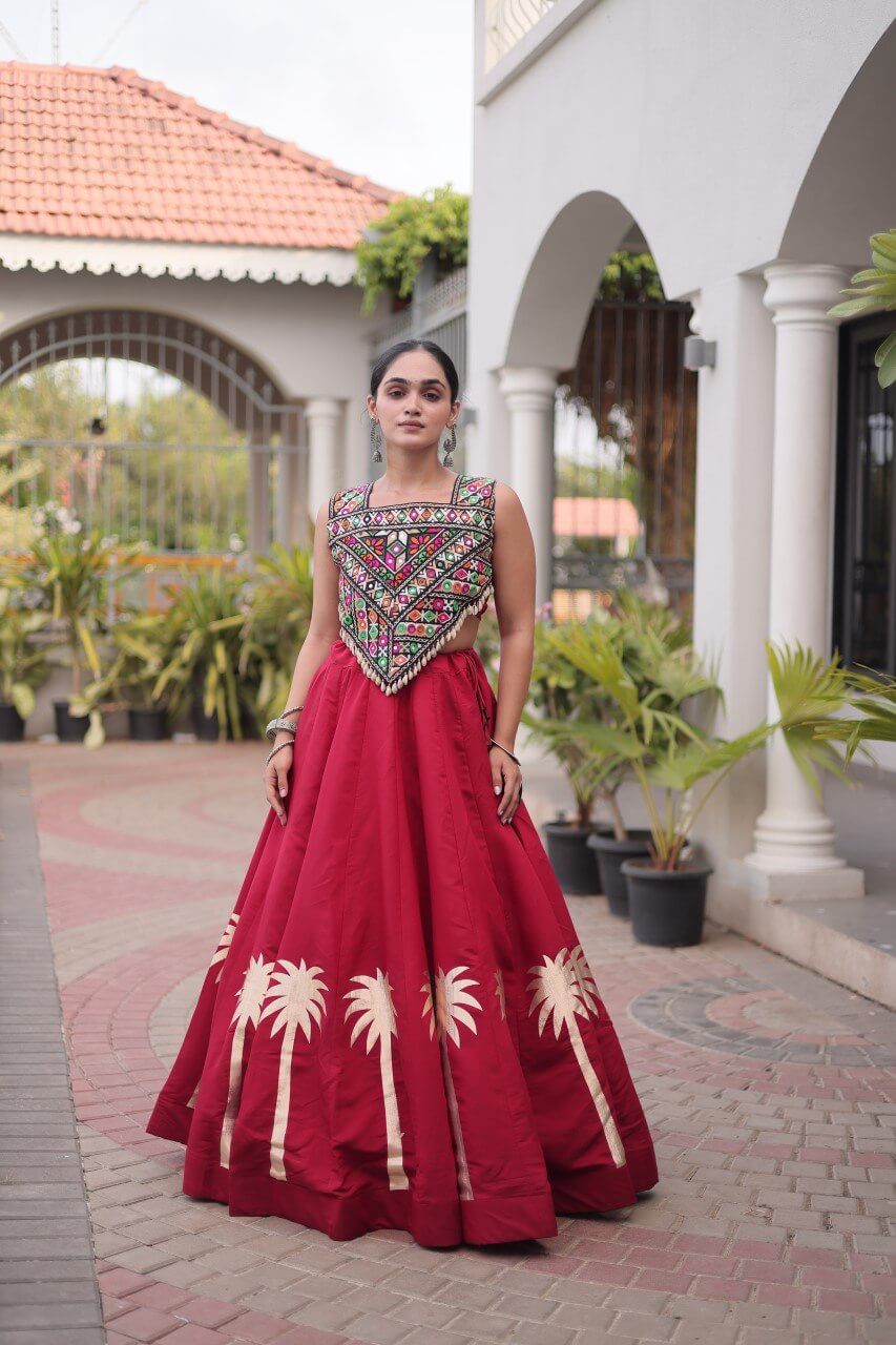 Red lehenga choli with multicolored patterned blouse and cream floral skirt detailing