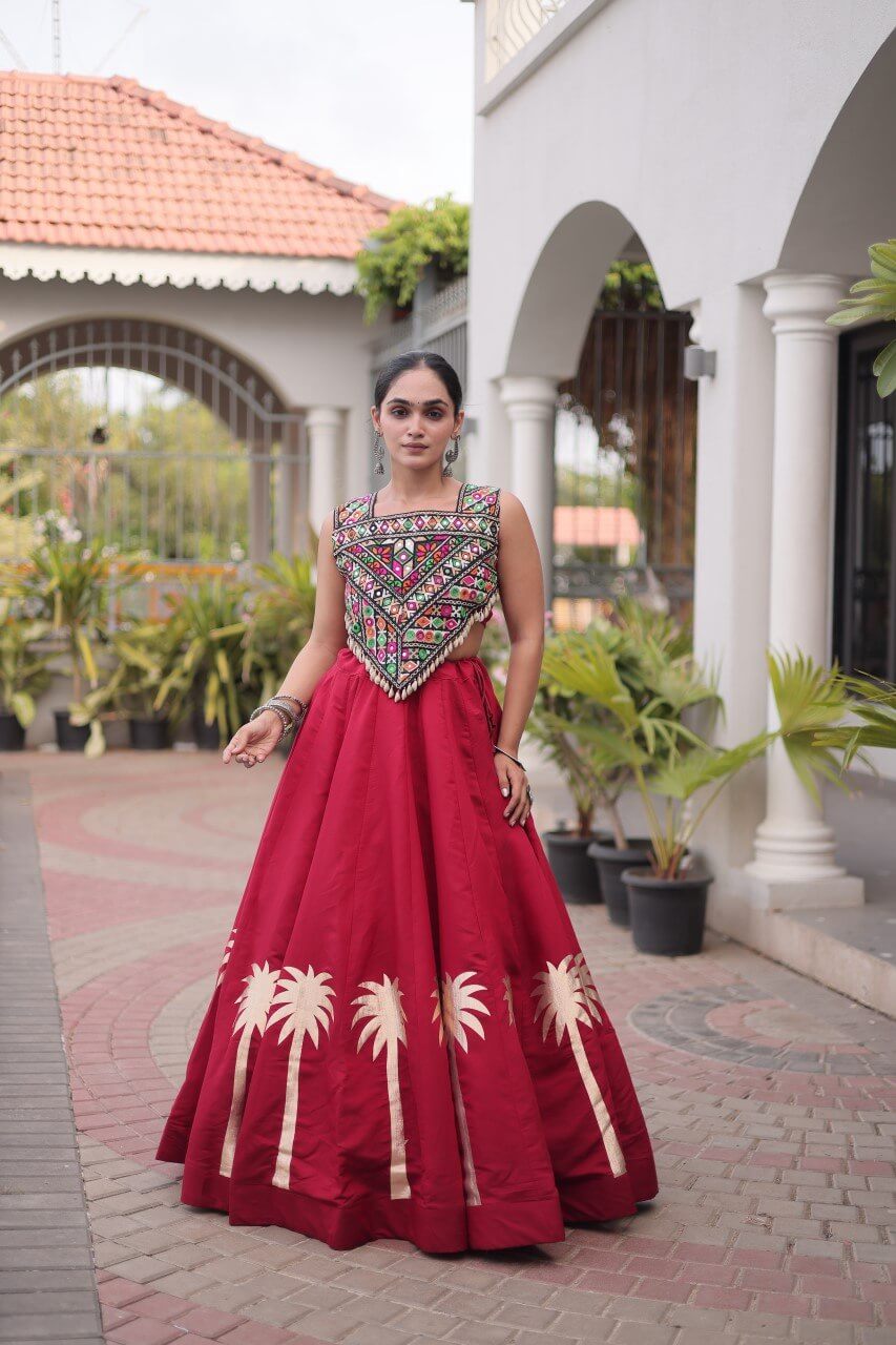 Red lehenga choli with multicolored patterned blouse and cream floral skirt detailing