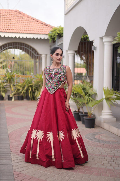 Red lehenga choli with multicolored patterned blouse and cream floral skirt detailing in a side view