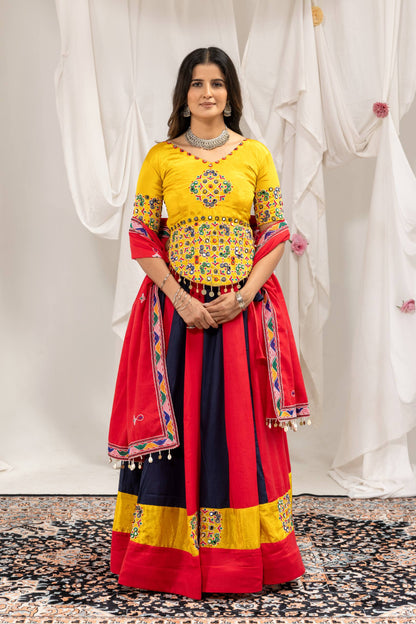Full-length front view of model standing in red and dark blue panelled lehenga choli set with matching red dupatta