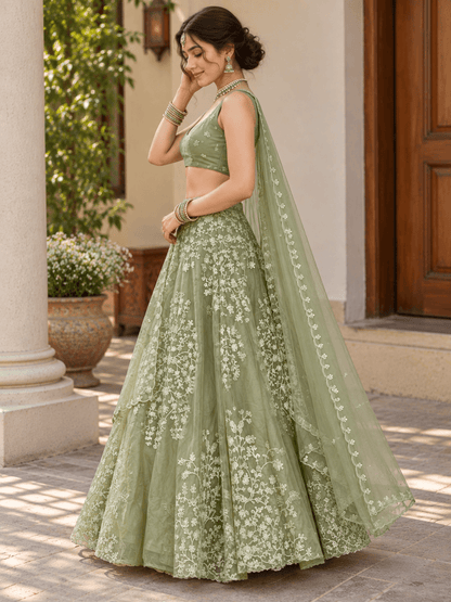 Side angle view of sage green embroidered lehenga choli showing drape of sheer scalloped dupatta