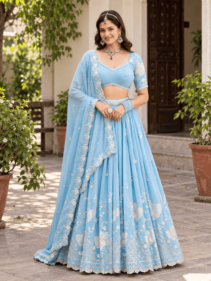 Full-length front shot of model in sky blue flared lehenga choli featuring floral embroidery and scalloped dupatta