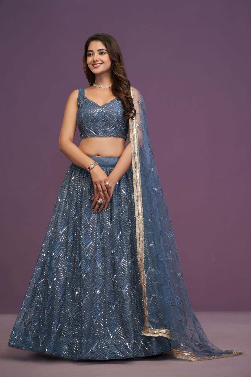 Full-length front view of model wearing slate blue embroidered sequin lehenga choli with gold border dupatta