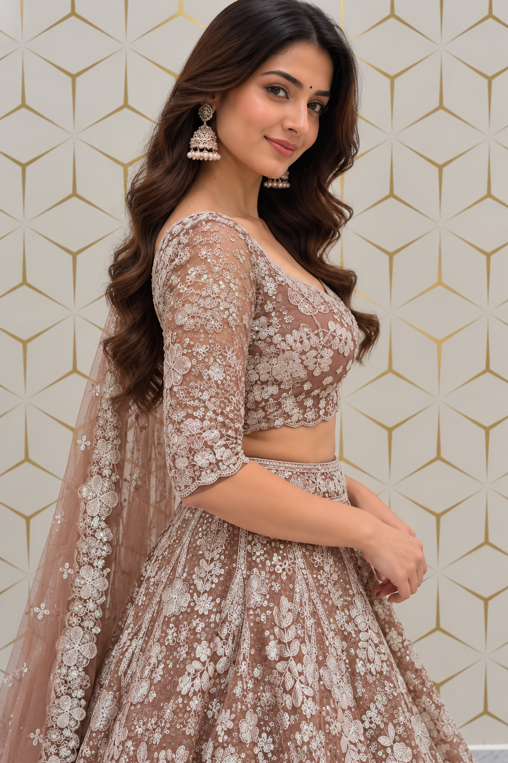 Three-quarter side profile portrait of a model wearing a taupe-mauve floral embroidered lehenga set with sheer embellished net dupatta.