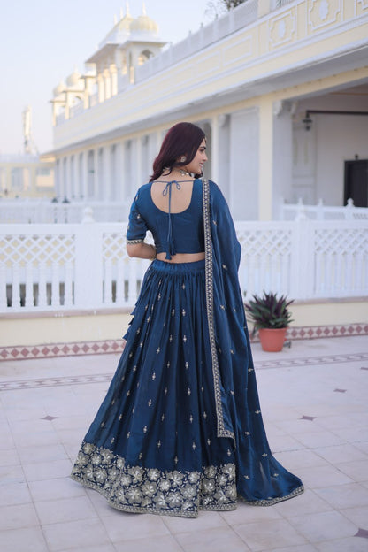 Full-length back view of a teal blue lehenga skirt and matching half-sleeve blouse with back dori tie-up