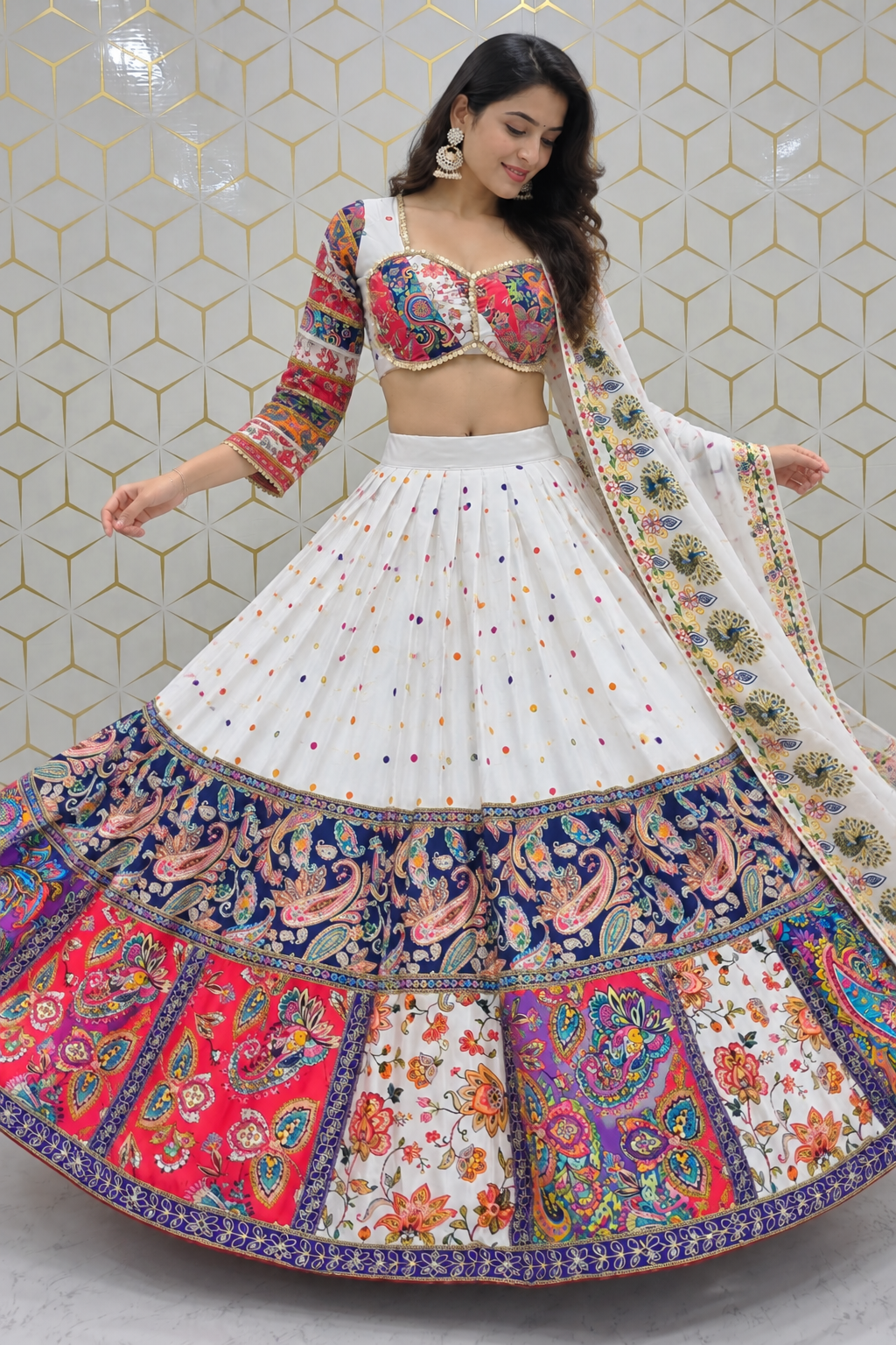 Full-length shot of a model holding the expansive circular flare of a white and multicolor printed lehenga skirt with three-quarter sleeve choli.