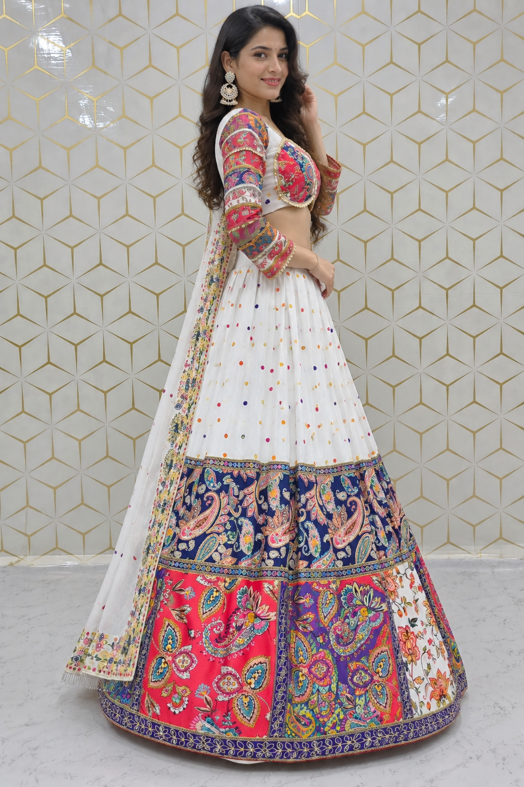 Side profile full-length view showing the flared circular silhouette of a white printed lehenga paired with a matching printed sheer dupatta drape.
