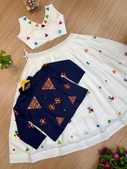 Flat lay view of white sleeveless crop top, pleated lehenga skirt, and buttoned blue embroidered jacket