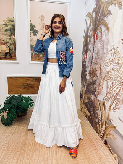 Model wearing a white flared ruffle lehenga and white crop top styled with an open blue embroidered jacket