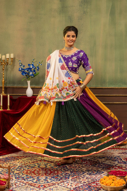 Flared twirling view of model showing full volume of yellow, dark green, and purple lehenga skirt with gold gota borders
