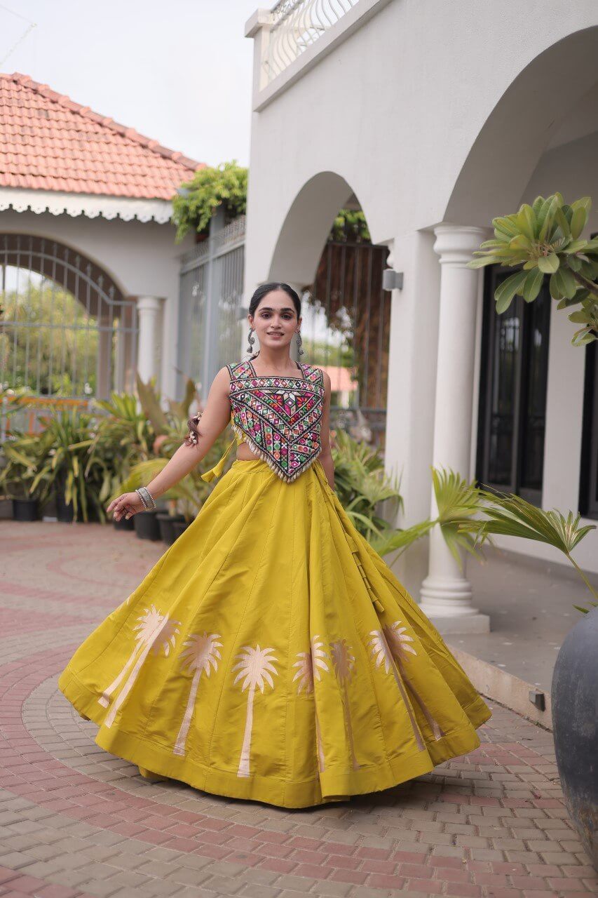 Yellow lehenga choli with a multicolored embroidered blouse and floral skirt detailing